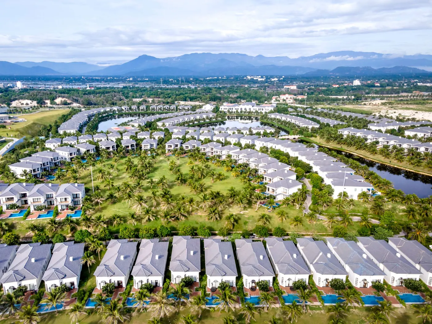Aerial view of paired villas in green landscaping